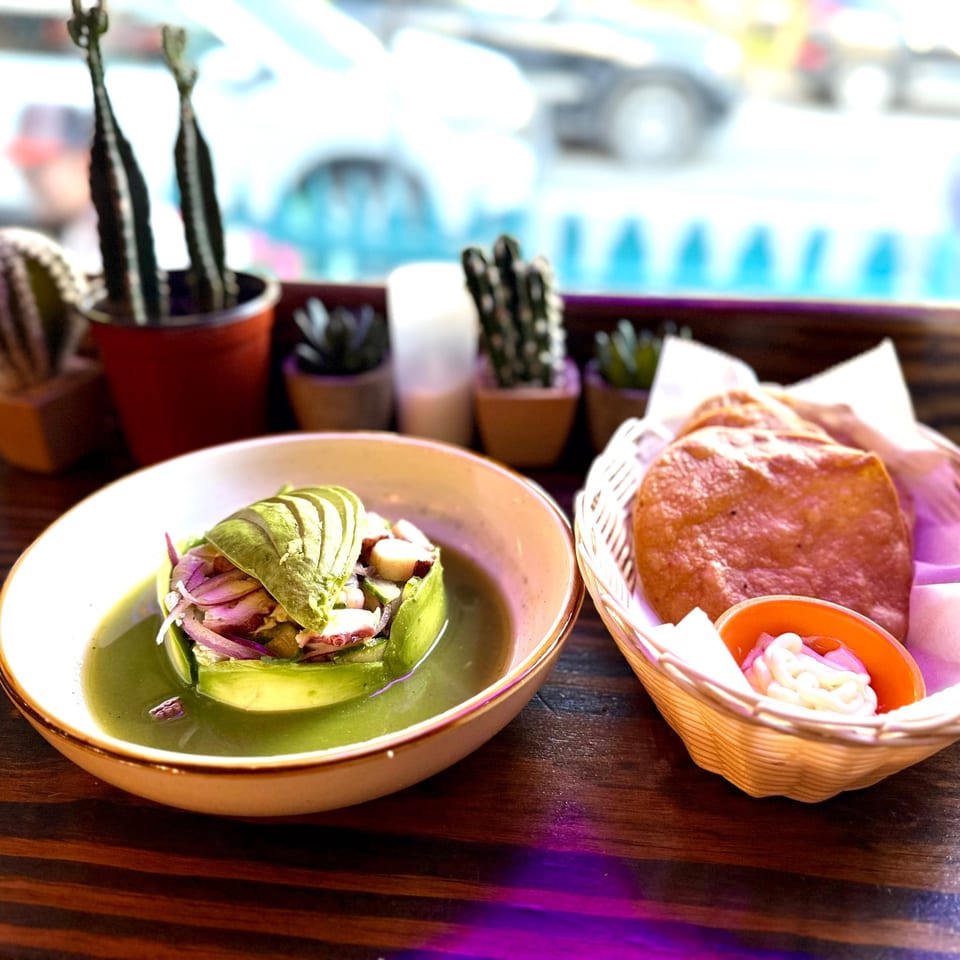Tuna tostadas with mango, cucumber, and avocado on a plate with dipping sauces.
